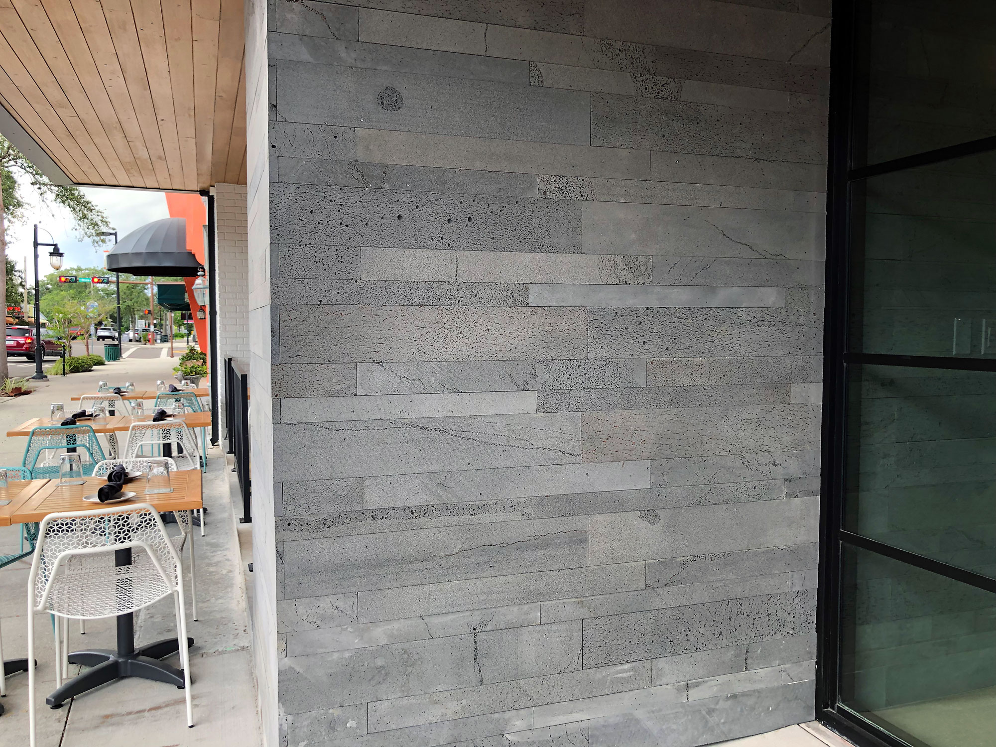 Entryway to a restaurant clad in Norstone Planc Series large format tile with an alternating overlap outside corner